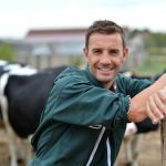 Herdsman,Standing,In,Front,Of,Cattle,In,Farm